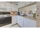 Kitchen with white cabinets, oven, and appliances, perfect for cooking enthusiasts at 418 Cerromar Ct # 261, Venice, FL 34293