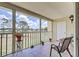 Enclosed patio with a nice chair set and a view of the lush grassy landscape at 418 Cerromar Ct # 261, Venice, FL 34293