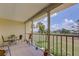 Enclosed patio with outdoor dining set and a relaxing view of the lawn and palm trees at 418 Cerromar Ct # 261, Venice, FL 34293