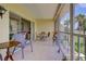Screened-in lanai featuring golf course views and comfortable patio furniture for relaxation at 418 Cerromar Ct # 261, Venice, FL 34293