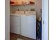 Simple laundry room with a washer, dryer, and some storage space at 418 Cerromar Ct # 261, Venice, FL 34293