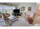 Cozy living room featuring a large seating area and a slider to the balcony at 418 Cerromar Ct # 261, Venice, FL 34293