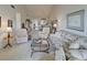 Bright living room boasts vaulted ceilings, neutral paint, carpet flooring and ample seating space at 418 Cerromar Ct # 261, Venice, FL 34293