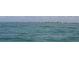 Expansive ocean view showcasing rippling waves stretching out to the distant shoreline with buildings on the horizon at 418 Cerromar Ct # 261, Venice, FL 34293