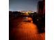 Illuminated pier at night, showcasing wooden planks and the lights of distant buildings reflecting on wet surface at 418 Cerromar Ct # 261, Venice, FL 34293