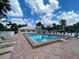 Community pool surrounded by lounge chairs, palm trees, and lush landscaping at 418 Cerromar Ct # 261, Venice, FL 34293