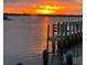 Sunset view over the water with a dock and boat silhouette in the foreground, creating a serene waterfront scene at 418 Cerromar Ct # 261, Venice, FL 34293