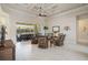 Relaxing living room featuring tiled floors, coffered ceiling, and seamless transition to outdoor patio at 4228 Corso Venetia Blvd, Venice, FL 34293