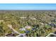 Aerial view of the homes nestled among mature trees, showcasing a serene and private community at 4324 Knowles Ln, North Port, FL 34288