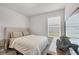 Cozy bedroom showcasing a comfortable bed, neutral color scheme, and bright natural light from the window at 4324 Knowles Ln, North Port, FL 34288