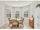 Bright dining area with bay window and wicker furniture at 4324 Knowles Ln, North Port, FL 34288