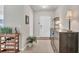 Bright foyer with tile flooring, a decorative table, and a view of the front door at 4324 Knowles Ln, North Port, FL 34288
