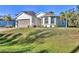 Two-story home featuring a two-car garage and a manicured lawn in a suburban neighborhood at 4324 Knowles Ln, North Port, FL 34288