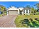 Charming two-story home with a brick driveway, a two-car garage, and well-maintained landscaping at 4324 Knowles Ln, North Port, FL 34288