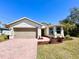 Charming single-story home featuring a brick driveway, attached garage, and well-maintained landscaping at 4324 Knowles Ln, North Port, FL 34288