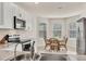 Bright kitchen and breakfast nook with white cabinets and stainless steel appliances at 4324 Knowles Ln, North Port, FL 34288