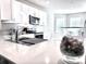 Bright kitchen with white cabinets, stainless steel appliances, and quartz countertops at 4324 Knowles Ln, North Port, FL 34288