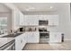 Bright kitchen with white cabinets, stainless steel appliances, and tile floor at 4324 Knowles Ln, North Port, FL 34288