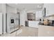 Bright kitchen with stainless appliances and white cabinets looking into the living room at 4324 Knowles Ln, North Port, FL 34288
