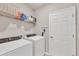 Laundry room equipped with a washer, dryer, shelving, and a door for easy access at 4324 Knowles Ln, North Port, FL 34288