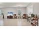 Living room with wicker chairs, tile flooring, and a view into a kitchen area at 4324 Knowles Ln, North Port, FL 34288