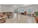 Spacious living room featuring tile flooring, a plush couch, and plenty of natural light at 4324 Knowles Ln, North Port, FL 34288