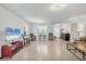 Open concept living room with tile flooring, view to kitchen and front foyer at 4324 Knowles Ln, North Port, FL 34288