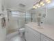 Bright bathroom features a glass-enclosed shower, a large vanity mirror, and modern fixtures at 435 Cerromar Ln # 326, Venice, FL 34293