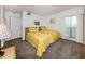 Comfortable bedroom with twin beds featuring yellow patterned bedding and a window with bright natural light at 435 Cerromar Ln # 326, Venice, FL 34293