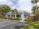 Community clubhouse featuring lush landscaping and ample parking at 435 Cerromar Ln # 326, Venice, FL 34293