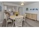 Cozy dining room area with seating for four and adjacent kitchen view at 435 Cerromar Ln # 326, Venice, FL 34293