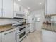 Updated kitchen with white cabinets, granite countertops, and stainless steel appliances at 435 Cerromar Ln # 326, Venice, FL 34293