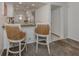 Modern kitchen with white cabinets, granite counters, and breakfast bar seating at 435 Cerromar Ln # 326, Venice, FL 34293