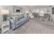 Inviting living area showcasing a blue sofa, accent furniture, and a view into the open floorplan dining area at 435 Cerromar Ln # 326, Venice, FL 34293