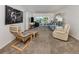 Light-filled living room with plush seating, neutral carpet, and balcony access offering seamless indoor/outdoor living at 435 Cerromar Ln # 326, Venice, FL 34293