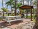 Community picnic area featuring a white picnic table, barbecue and shade at 435 Cerromar Ln # 326, Venice, FL 34293