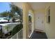 Inviting condo entry featuring a covered porch with white railings, a bright front door, and a 'Welcome' mat at 440 Cerromar # 404, Venice, FL 34293