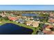 Aerial view of property in a lakeside community with well-maintained landscaping at 456 Pinewood Lake Dr, Venice, FL 34285