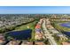 Aerial view of property in community near golf course, lakes, and many attractive homes at 456 Pinewood Lake Dr, Venice, FL 34285