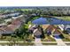 Beautiful aerial view of homes surrounding a tranquil lake and golf course, showcasing a serene community setting at 456 Pinewood Lake Dr, Venice, FL 34285
