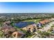Aerial view of property located near golf course and lake in an upscale community at 456 Pinewood Lake Dr, Venice, FL 34285