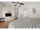 Bright bedroom with light wood floors, white furnishings and ensuite bathroom entrance at 456 Pinewood Lake Dr, Venice, FL 34285