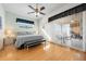 Spacious bedroom features a ceiling fan, laminate floors, and sliding door leading to patio at 456 Pinewood Lake Dr, Venice, FL 34285