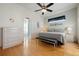 Primary bedroom features a ceiling fan, laminate floors, and ensuite bathroom at 456 Pinewood Lake Dr, Venice, FL 34285