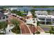 Community view showcasing pedestrian-friendly areas, retail spaces, and manicured landscaping near the lake at 456 Pinewood Lake Dr, Venice, FL 34285