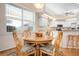 Cozy dining area adjacent to the kitchen, featuring a round table, comfortable seating, and ample natural light at 456 Pinewood Lake Dr, Venice, FL 34285