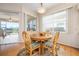 Bright dining nook with a round table and a view of the screened lanai, providing a relaxing dining space at 456 Pinewood Lake Dr, Venice, FL 34285