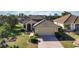 Charming single-story home with a well-maintained lawn and a two-car garage, set in a tranquil, lush community at 456 Pinewood Lake Dr, Venice, FL 34285