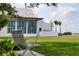 Modern building with pergola and glass windows overlooks well-manicured lawn, seen from park bench at 456 Pinewood Lake Dr, Venice, FL 34285