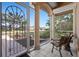 Inviting front porch with tile flooring and decorative metal door, providing a charming entrance to the home at 456 Pinewood Lake Dr, Venice, FL 34285